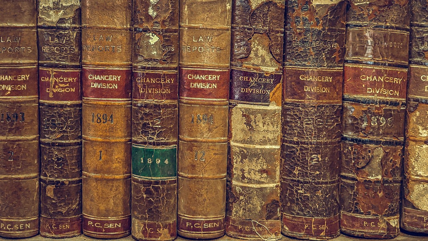 Bound legal volumes on a shelf, their spines lettered in gilt.