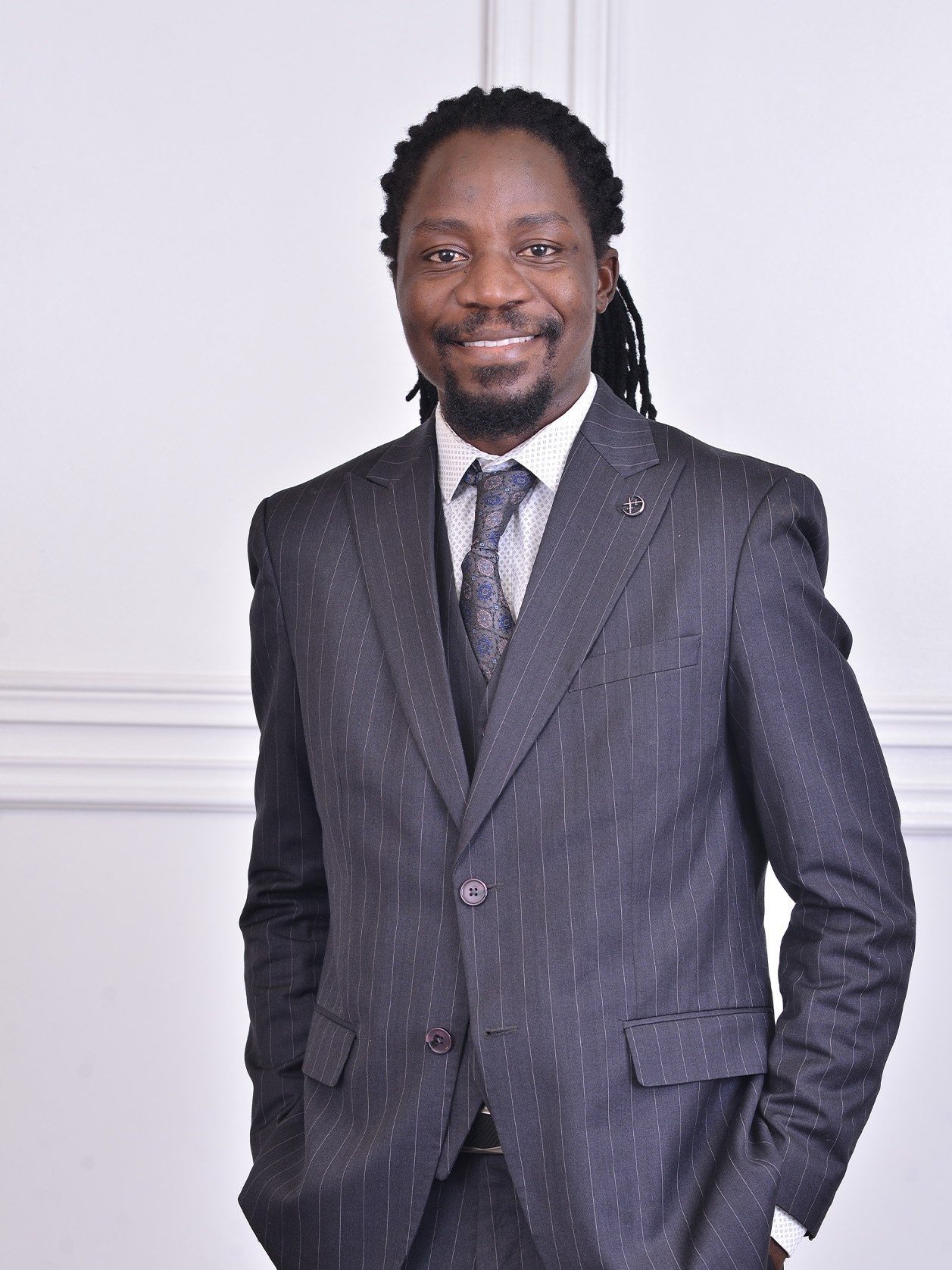Chamu RM Chingwe-Gangata, Principal of the firm, in a pinstripe suit.